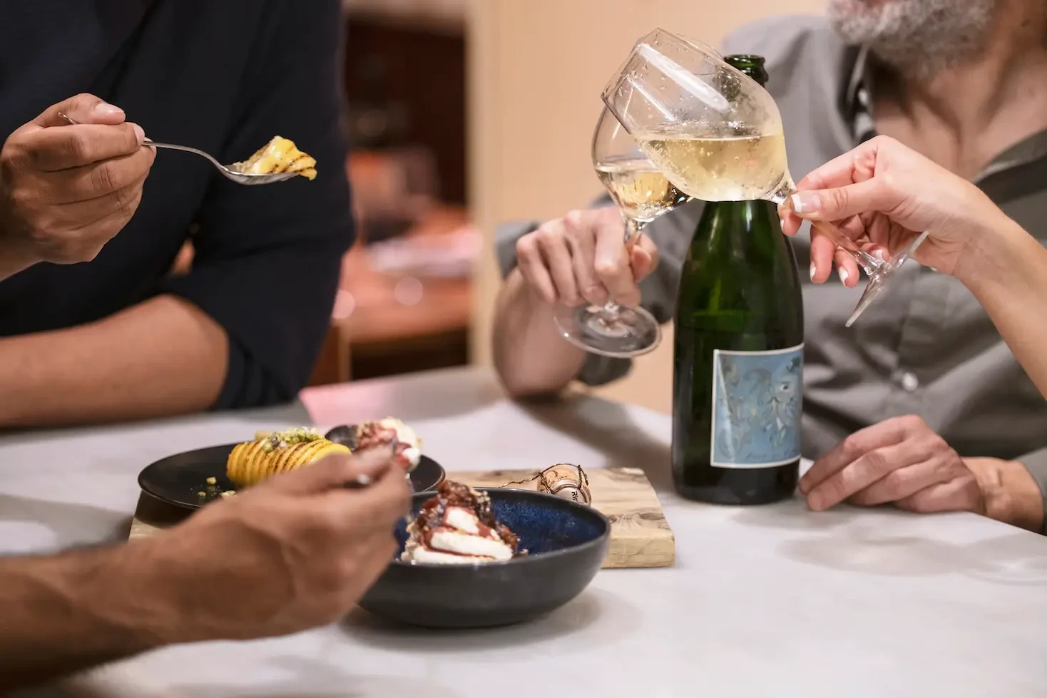 a group sharing some tapas and drinking cava