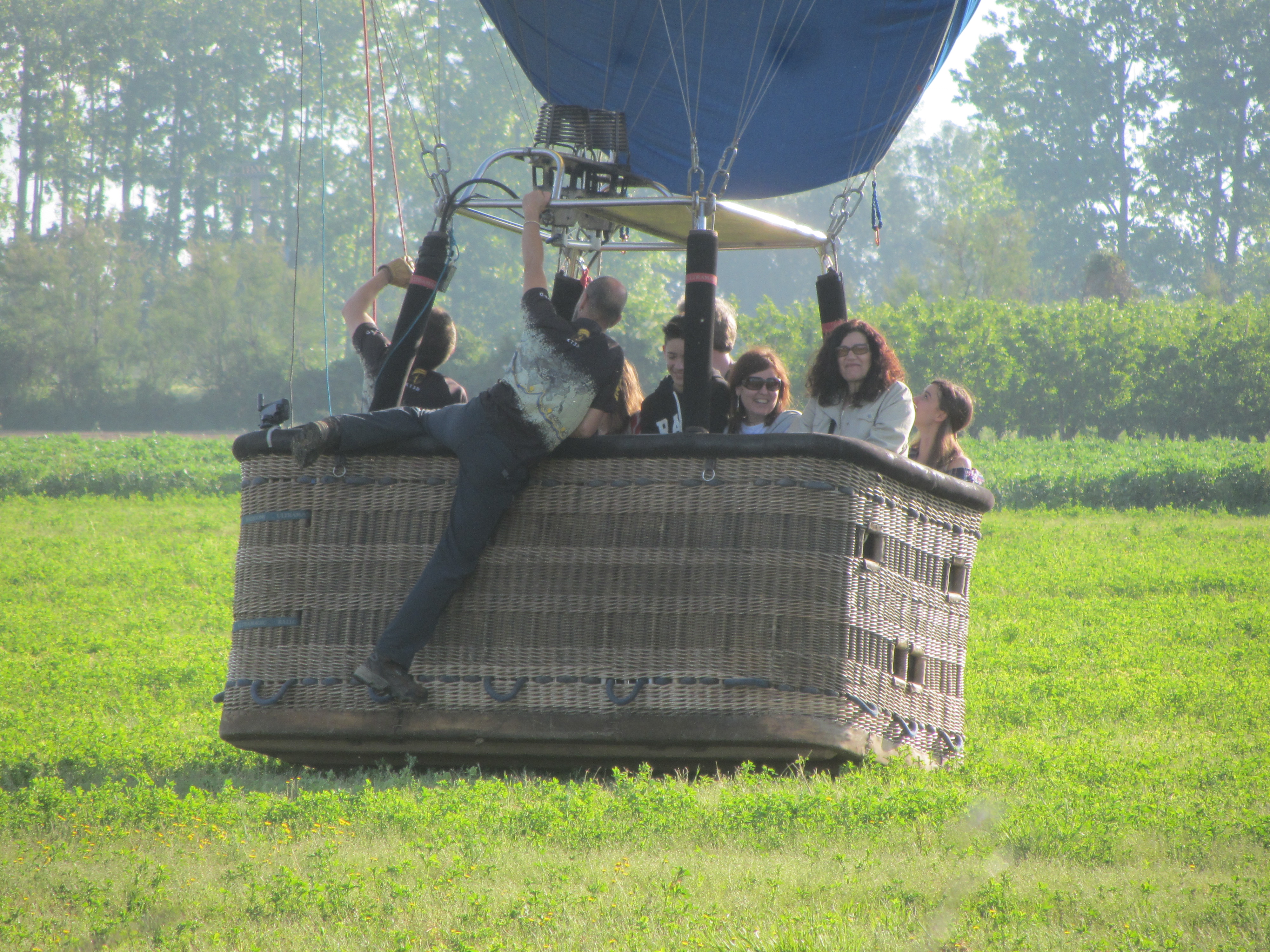 Hot air balloon basket landing in a field