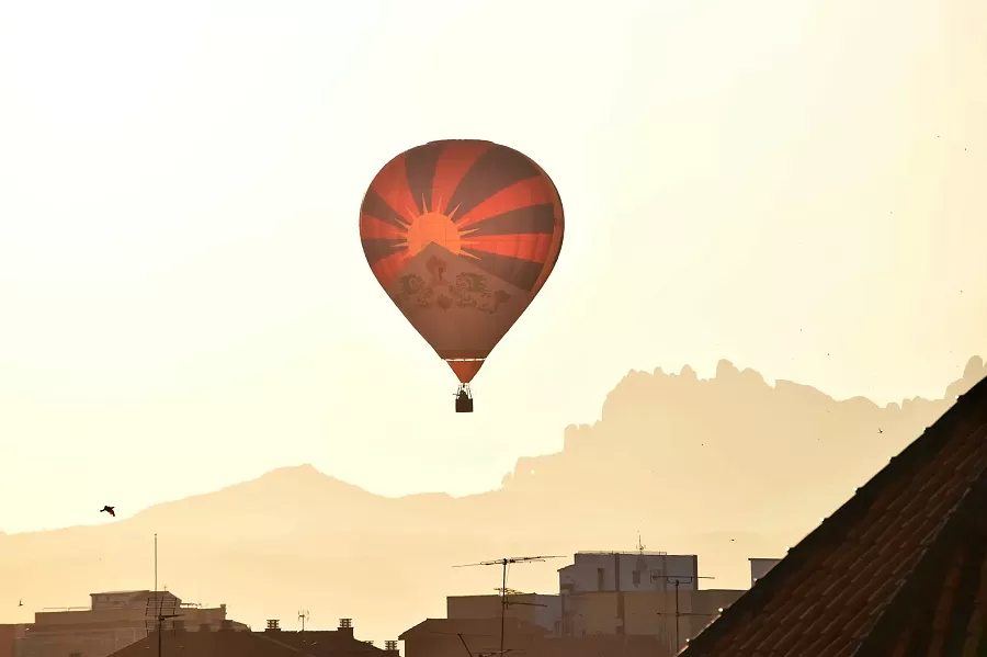 A hot air balloon eclipsing the morning sun