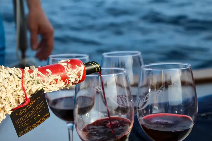 Serving red wine on a sailing boat